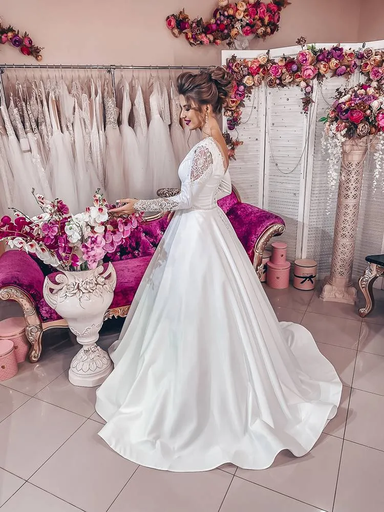 ---Very elegant and romantic fairytale wedding dress made of satin with a sensual deep V neckline and long embroidered sleeves--