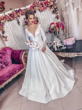 ---Very elegant and romantic fairytale wedding dress made of satin with a sensual deep V neckline and long embroidered sleeves--