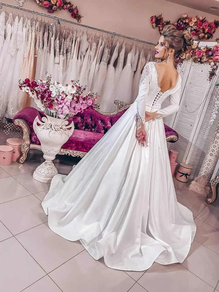 ---Very elegant and romantic fairytale wedding dress made of satin with a sensual deep V neckline and long embroidered sleeves--