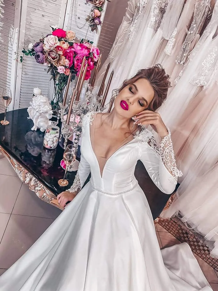 ---Very elegant and romantic fairytale wedding dress made of satin with a sensual deep V neckline and long embroidered sleeves--